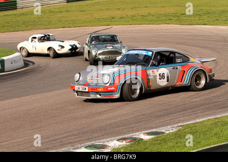 Martini Porsche chased by an Austin-Healey and Jaguar e-type at the hair pin at Mallory Park on the Tour Britannia 2010 Stock Photo