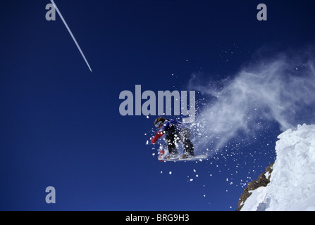 Male snowboarder flying through the air. Stock Photo