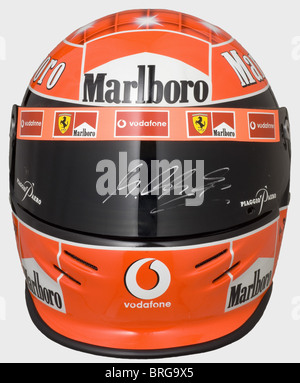 Michael Schumacher,a racing helmet of the seven-time Formula 1 world champion,2002 season The visor with signs of use,handsigned by Michael Schumacher.Authentically produced in limited quantity,this authorised replica bears a special airbrush painting and seven stars for his seven world championship titles in the 'starry sky'(from 2004).Provenance: Donington Grand Prix Collection,exhibited also at the Goodwood Festival of Speed or the Retromobile in Paris.When one of Schumacher's helmets was stolen from the Brunswick manufacturer in 2002,the object va,Additional-Rights-Clearences-Not Available Stock Photo
