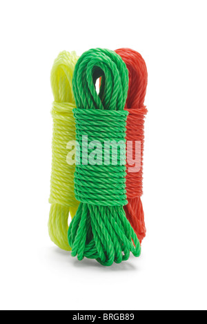 Three bundles of colorful nylon ropes standing together on white background Stock Photo