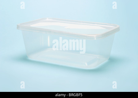 Empty transparent plastic container on blue background Stock Photo