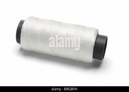 Bobbin of white thread on white background Stock Photo