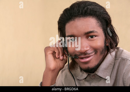 one twenties African American male business worker talking on a headset Stock Photo