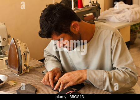 man learning to become a tailor in Kabul Afghanistan Stock Photo