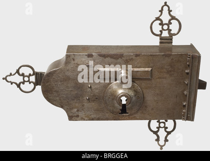 A large French gate lock with two keys,dated 1772 Heavy iron lock housing with three fine openwork mounting plates on the sides(two broken at the base).There is a central keyhole on the front for the main key beneath a handle for opening the spring bolt.Riveted decorative edge cut with the date "1772".The back has key guides for the large and small keys.It comes with both of the original keys with ornate bits.The large key locks both the spring bolt as well as the two side wards.The small key only locks the central spring bolt.Width of the lock 39 cm.,Additional-Rights-Clearences-Not Available Stock Photo