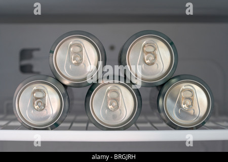 five cans of beer chilling in a fridge Stock Photo