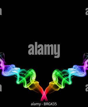 two streams of rainbow colored smoke streaming up and left on a black background Stock Photo