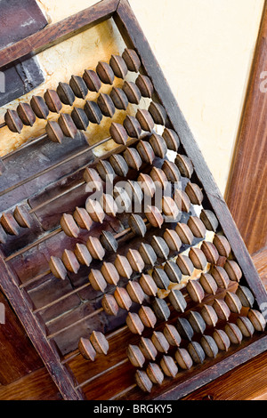 vintage big wooden abacus as decoration element on wall Stock Photo