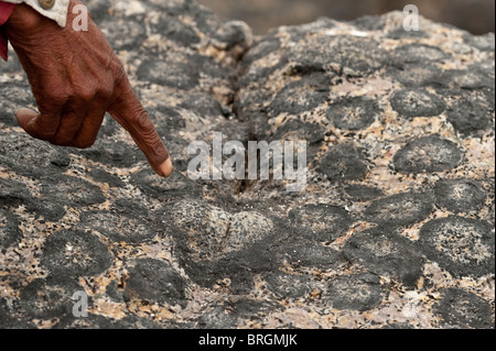 Mr Hipolito Avalos pointing out detail in Granito Orbicular Santuario de la Naturaleza Rodillo Atacama Chile South America Stock Photo