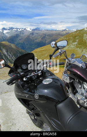 Motorcycles on the parking lot on the top of the Nufenen Pass, Valais, Switzerland Stock Photo