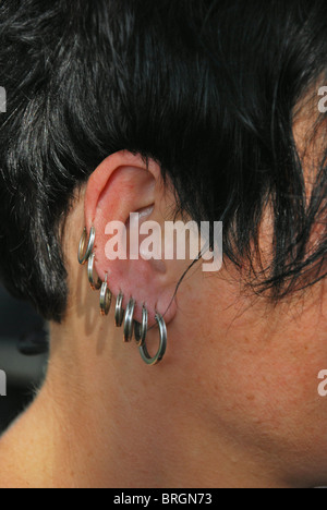 adolescent girl with multiple earrings Stock Photo