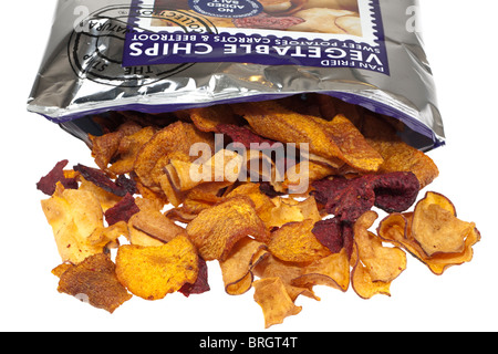 Opened packet of sweet potato and beetroot fried vegetable chips spilling onto a white surface Stock Photo