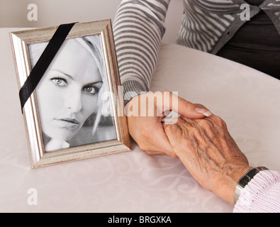 Holding hands for comfort. Grief at death. Stock Photo