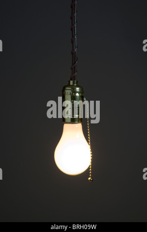 One light bulb hanging on white background Stock Photo - Alamy