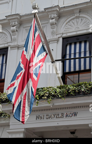 The Union flag flying of the Gieves & Hawkes traditional men's clothing store at No 1 Savile Row, London, UK Stock Photo