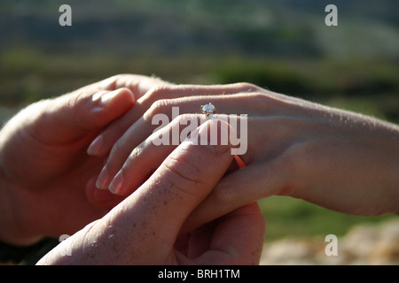 putting on an engagement ring Stock Photo