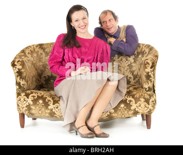 happy kitsch couple in love on old fashioned sofa Stock Photo