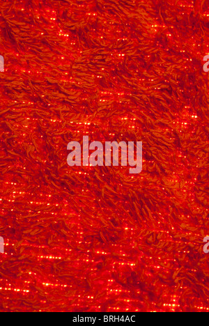 Red Towelling background with light showing through Stock Photo
