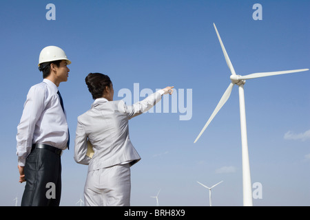 Engineers in front of wind turbines Stock Photo