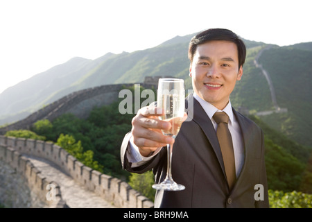 Businessman having champagne on the Great Wall Stock Photo