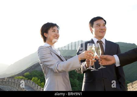 Businesspeople having champagne on the Great Wall Stock Photo