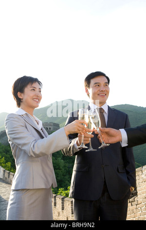 Businesspeople having champagne on the Great Wall Stock Photo