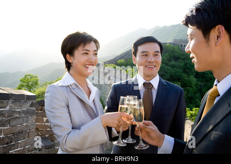 Businesspeople having champagne on the Great Wall Stock Photo