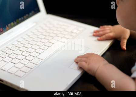 Baby using laptop Stock Photo