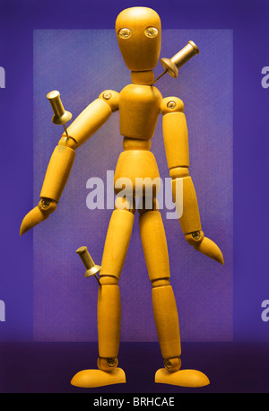 Wooden Figure with Pushpins in Joints Stock Photo
