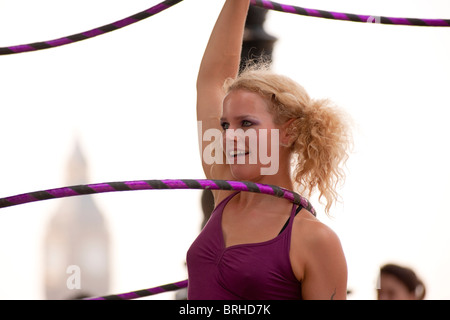 Hula Hooper Lisa Lotti performs on London's South Bank with Big Ben in the background.