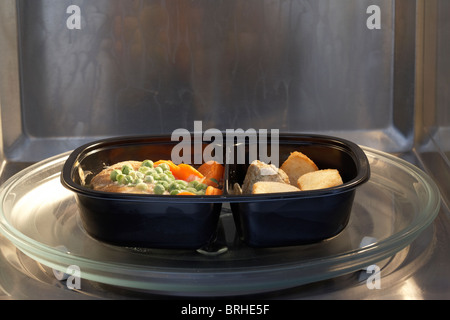 frozen microwave chicken dinner meal for one in a microwave ready to cook Stock Photo