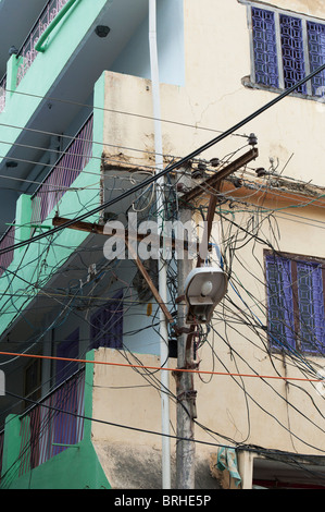 Electricity pylon, cables and street lamp in an Indian street of Puttaparthi. Andhra Pradesh, India Stock Photo
