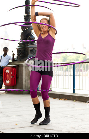 Hula Hooper Lisa Lotti performs on London's South Bank with Big Ben in the background. Stock Photo