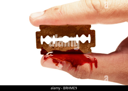 fingers keep the old rusty razor with blood on a white background Stock Photo