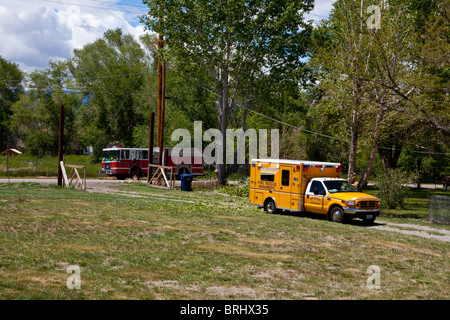 A rural fire departments paramedics treating a man injured by a falling tree Stock Photo