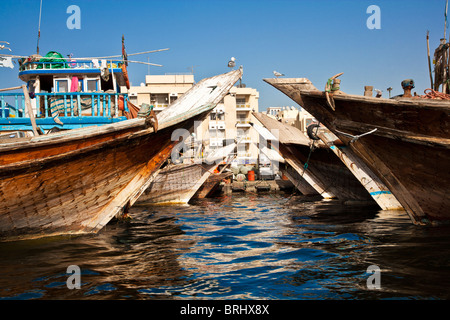 Traditional Arabian boats or Dhows moored along the Dubai Creek in Deira, Old Dubai, United Arab Emirates, UAE Stock Photo