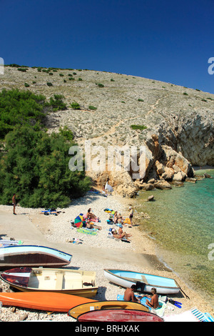 People resting on a beach in Koromacna Bay near Belej village on Cres Island, Croatia Stock Photo