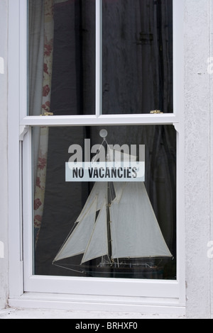 A No Vacancies sign in a Cornish guest house window Stock Photo