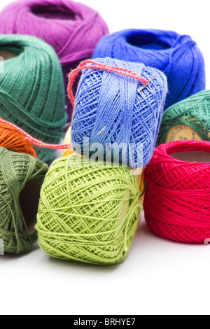 Close-up of multicolored spools of embroidery thread on white background Stock Photo