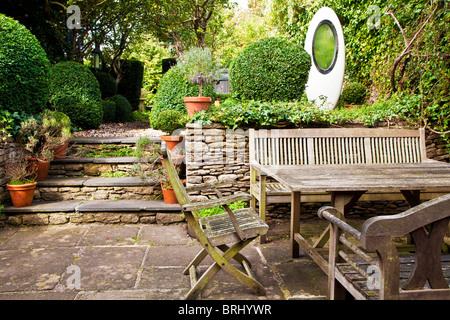 The garden of an English country house designed by Rosemary Verey with a modern water feature by Simon Percival Stock Photo