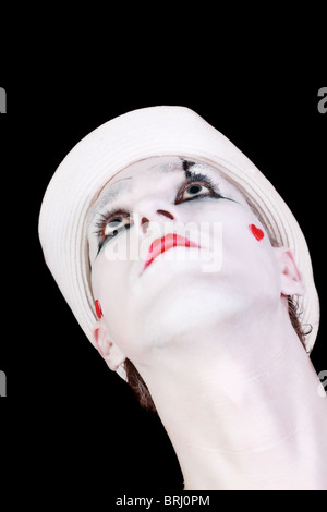 Portrait of mime in white hat isolated on black background Stock Photo