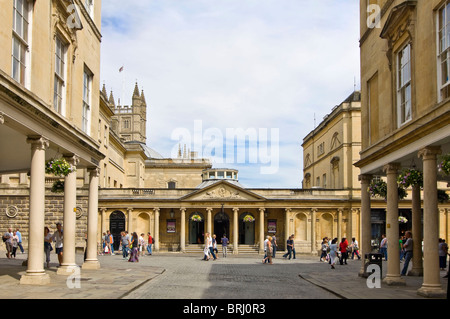 Horizontal wide angle of tourists and people outside the historic Roman Baths in Bath city centre in the sunshine Stock Photo