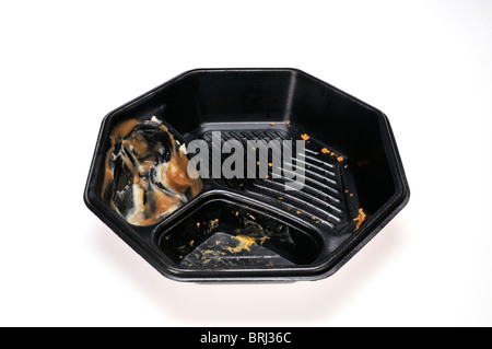 Empty black plastic fast food takeaway take out container after finished eating meal isolated on white Stock Photo