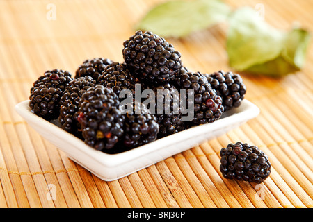 blackberries isolated on a bamboo mat background Stock Photo