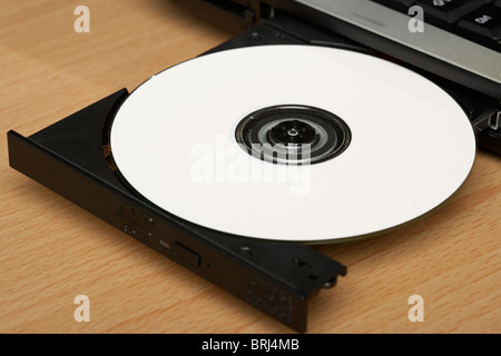 white cd in laptop cd dvd tray Stock Photo