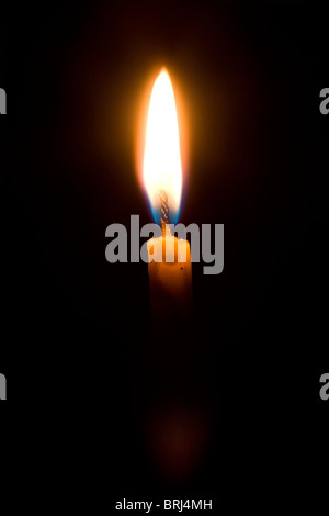 Candle lighting in the dark close-up Stock Photo