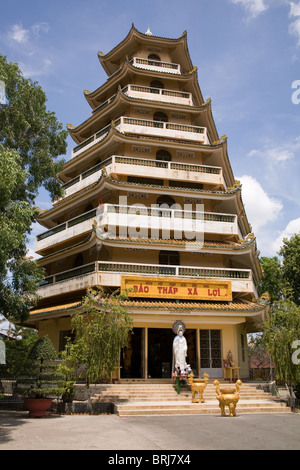Giac Lam Pagoda in Ho Chi Min City, Vietnam, A statue of Quan Am stands at the entrance to the seven-storied stupa Stock Photo