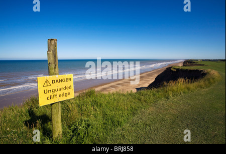 Warning sign on cliffs above Skipsea beach, East Yorkshire Stock Photo