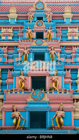 Indian gopuram temple architecture in the South Indian town of Puttaparthi showing hindu deities. The entrance to the ashram of Sathya Sai Baba Stock Photo