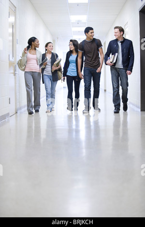 High school students walking down school corridor Stock Photo